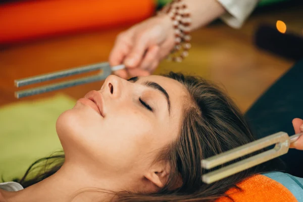 Relaxing Woman Receives Healing Therapy at Home