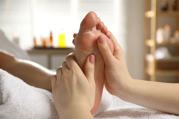 Therapist putting pressure on feet