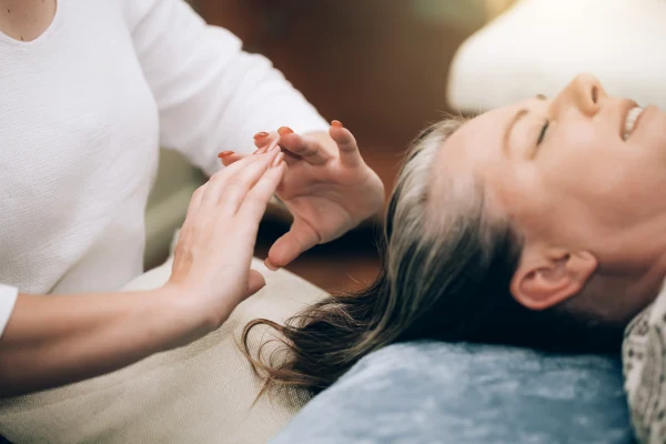 Woman Receives Calm Healing Session Indoors at Home